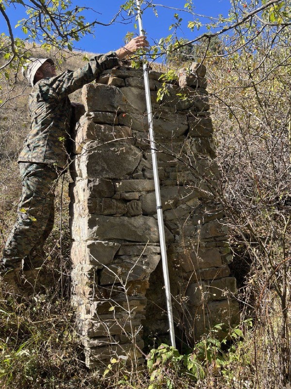 Employees of the Dzheyrah-Assinsky Museum-Reserve carried out planned work on accounting and fixation of previously unrecorded objects of cultural heritage.

This time the trip was made to the rarely visited tower complex in the eastern part of the Guloikhi Gorge - "Besht", where the ruins of four residential towers are preserved.

The described monument - a pillar-shaped sanctuary or, as it is popularly called, sieling - is located 300 meters west of the complex. Its height is 2.50 m, length is 1.10 m, width is 0.65 m. Below, on the facade of the object there is a lancet beggar with a height of 0.8 m.

In his studies, the Ingush historian and archaeologist M.B. Muzhukhoev believed that pillar-shaped sanctuaries complete the evolution of local religious monuments. And some scientists, on the contrary, believe that pillar-shaped structures are the primary form of religious buildings.

M.B. Musukhoev also claims that the construction of sielings was performed in memory of deceased ancestors. These monuments served as a symbol of veneration and respect for ancestors, and were believed to provide invisible protection to their descendants.

Ethnographic descriptions acquaint us with monolithic "pillars" - sanctuaries known as "Sielings", indicating their mythological connection with the cult of "the sun god" and lightning "Selya". A typical example of the sanctuary-monument is the sielings near the village of Erzi, Egikal, Targim, Niy, Vovnushki, Ozdeche, etc. in Ingushetia.

Researcher F.M. Kostoeva believes that in ancient times, the term "seeling" was used to refer to a high quadrangular stone column facing south, with a flat or gable top and a small niche at the base. The sielings were collected from raw stone before human growth and fixed to a lime or clay solution ("markhal"). Such stone structures were erected at crossroads, at towers or crypts.

As for this structure, we did not find its description in any written source. Employees carried out measurements of the object, photofixation. The monument will be included in the list of identified objects of cultural heritage of the republic, as well as put into scientific circulation, and it will be of interest to all who are interested in the history of Ingushetia.